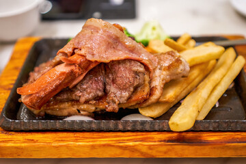 Delicious American barbecue platter, steak, bacon, sausage and fries platter