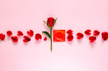 Red rose with petals and condom package for minimal safe sex, world sexual health and aids day concept.