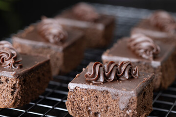 Cubes of chocolate brownie on a colling rack.