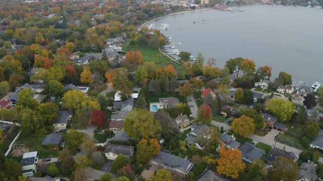 High Aerial View Of Lake Geneva, Wisconsin In Fall. Beautiful Autumn Landscape. Pan Up