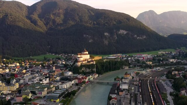 Aerial view of mountain town Kufstein with hilltop fortress,  summer scenery at sunrise, river Inn meandering through the valley - Austrian Alps from above, Tyrol, Austria, Europe