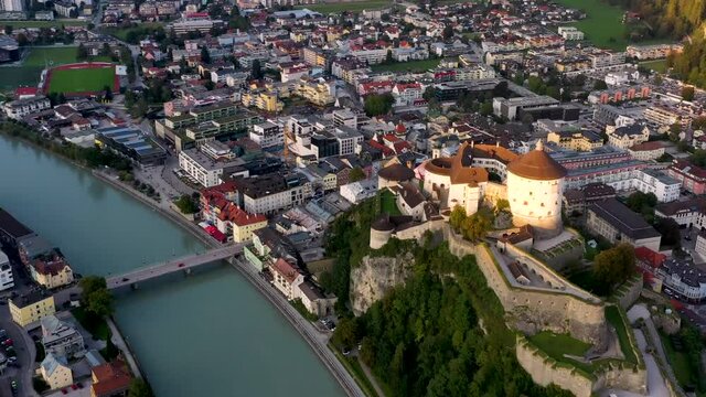 Drone view of mountain town Kufstein with hilltop fortress,  summer scenery at sunset, river Inn, Austrian Alps from above, Tyrol, Austria, Europe