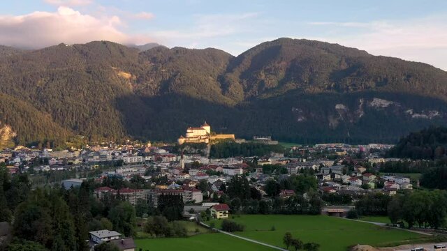 Aerial view of mountain town Kufstein with hilltop fortress,  summer scenery at sunrise, river Inn meandering through the valley - Austrian Alps , Tyrol, Austria, Europe.