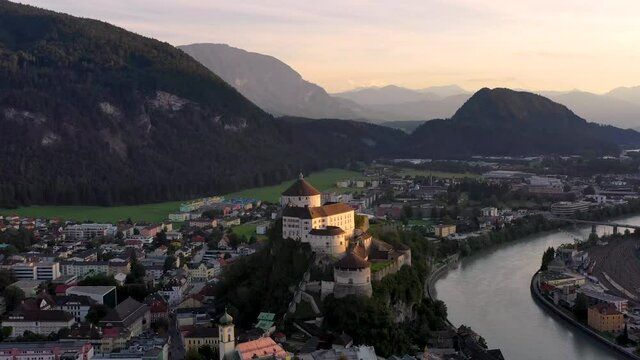 Aerial footage of mountain town Kufstein with hilltop fortress,  summer scenery at sunrise, river Inn meandering through the valley - Austrian Alps from above, Tyrol, Austria, Europe