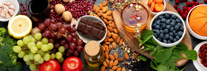 Selection of healthy food high in antioxidants on dark gray background. Clean eating concept.