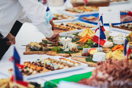 Shallow depth of field (selective focus) image with people eating french cuisine aperitifs from a table.