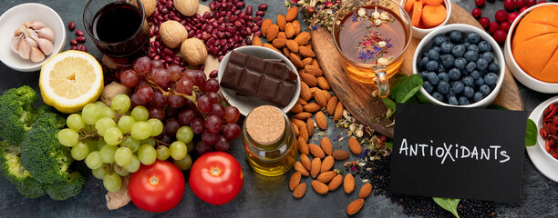 Selection of healthy food high in antioxidants on dark gray background. Clean eating concept.