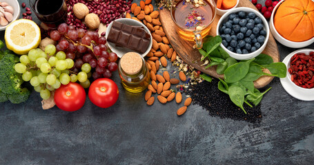 Selection of healthy food high in antioxidants on dark gray background. Clean eating concept.