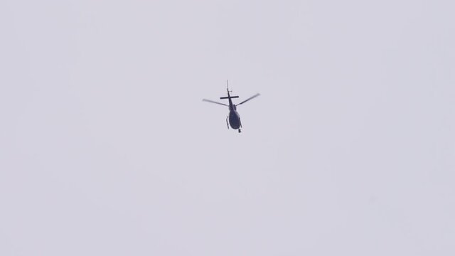 Helicopter in the sky with a huge camera attached to it to film news
