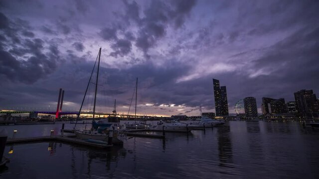 Sunset timelapse video of Bolte Bridge with Melbourne Star Observation Wheel at District Docklands in Melbourne CBD, Australia