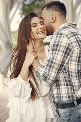 Beautiful couple spend time in a summer park