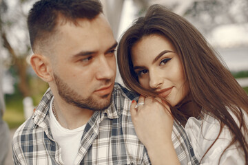 Beautiful couple spend time in a summer park