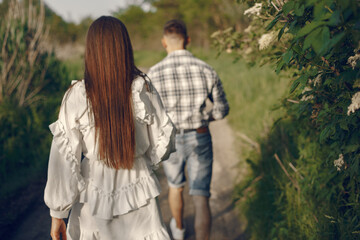 Beautiful couple spend time in a summer park