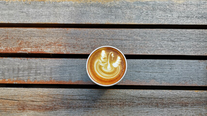 a cup of latte art coffee on wooden background                                                                                                                                      