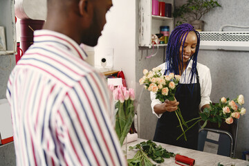 Portrait of joyful African American people in flower store