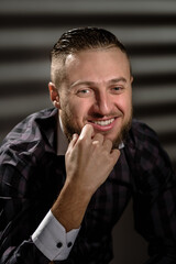 Closeup portrait of young handsome laughing businessman dreaming