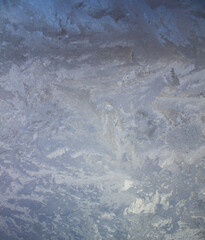 Textured frost patterns on the glass. Ice crystals on the window on a cold, frosty day in winter.