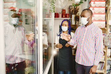 Portrait of joyful African American people in flower store