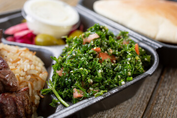 A view of a side of tabbouleh, part of a Mediterranean entree.