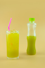 Sugarcane juice in plastic bottles with sugarcane juice in glass