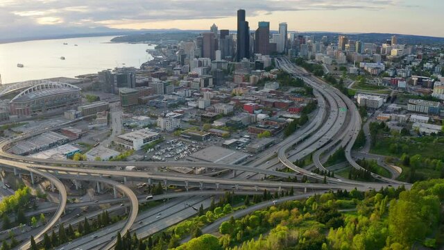 Backward Flight Revealing City Freeway System Winding and Curving with Cars