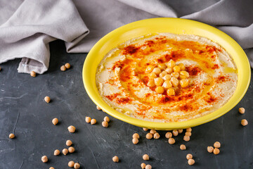traditional turkish hummus on a dark stone background
