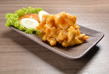 deep fried chicken with lemon sauce and sesame on wood background asian halal menu