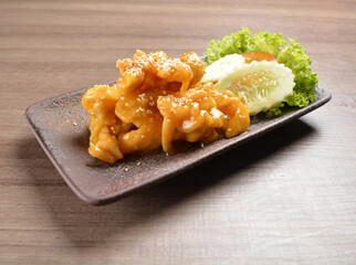 deep fried chicken with lemon sauce and sesame on wood background asian halal menu