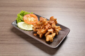stir fried chicken meat with garlic and honey sauce on wood background asian halal menu
