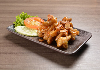 stir fried chicken meat with garlic and honey sauce on wood background asian halal menu