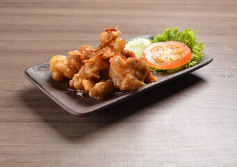 stir fried chicken meat with garlic and honey sauce on wood background asian halal menu