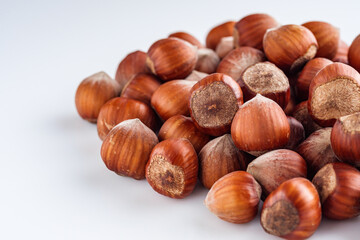fresh natural hazelnuts on a white acrylic background