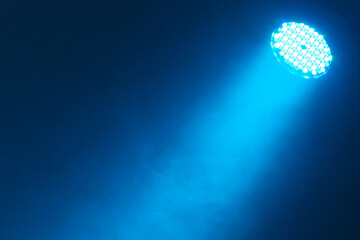 Spotlight beam on a blue background.