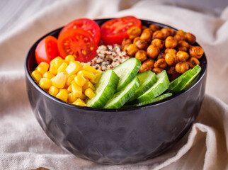 bowl of healthy quinoa with vegetables on a white rustic wooden background