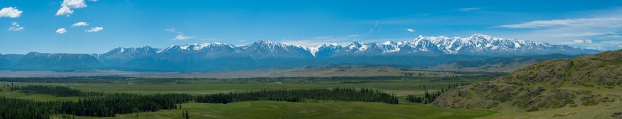 Fototapeta na wymiar Panoramic view of the Kuraiskaya steppe and the snow-covered mountain slopes of the Chuisky ridge, Altai photo