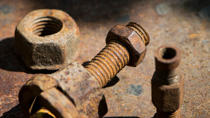 old rusty bolt, iron rod with screw threads. Rusted mechanical components. threaded bolt and nut. dismantling concept, difficult to unscrew, non-removable. selective focus, close-up, macro