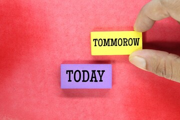 hands holding colored cubes with the words today and Tomorrow