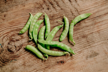 young peas on a wooden background. the view from the top