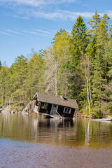Obraz premium View of Tampaja lake and tilted sauna also known as the Drunken Sauna, Kirkkonummi, Finland