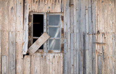 Broken window of an abandoned wood house