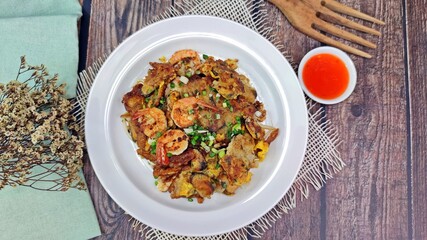 Crispy fried mussels pancake served with chilli sauce. Thai food.
