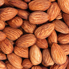 Background of almonds. Fried almonds. Scattered almond grains. Background for advertising