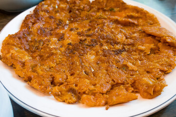 Delicious korean style kimchi pancake on a plate.