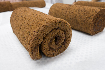 chocolate roll with cream on a white background.