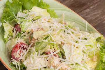 Chicken salad with iceberg lettuce on the wooden table