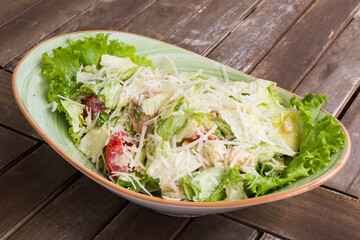 Chicken salad with iceberg lettuce on the wooden table