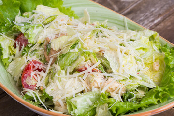 Chicken salad with iceberg lettuce on the wooden table