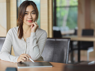 Portrait of businesswoman smiling in working space , office background