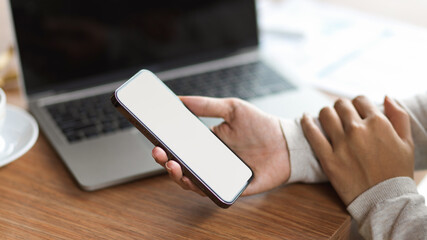 Cropped shot of businessman holding mobile phone with blank screen