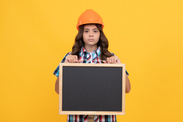 serious child in helmet presenting school blackboard with advertisement, copy space, school